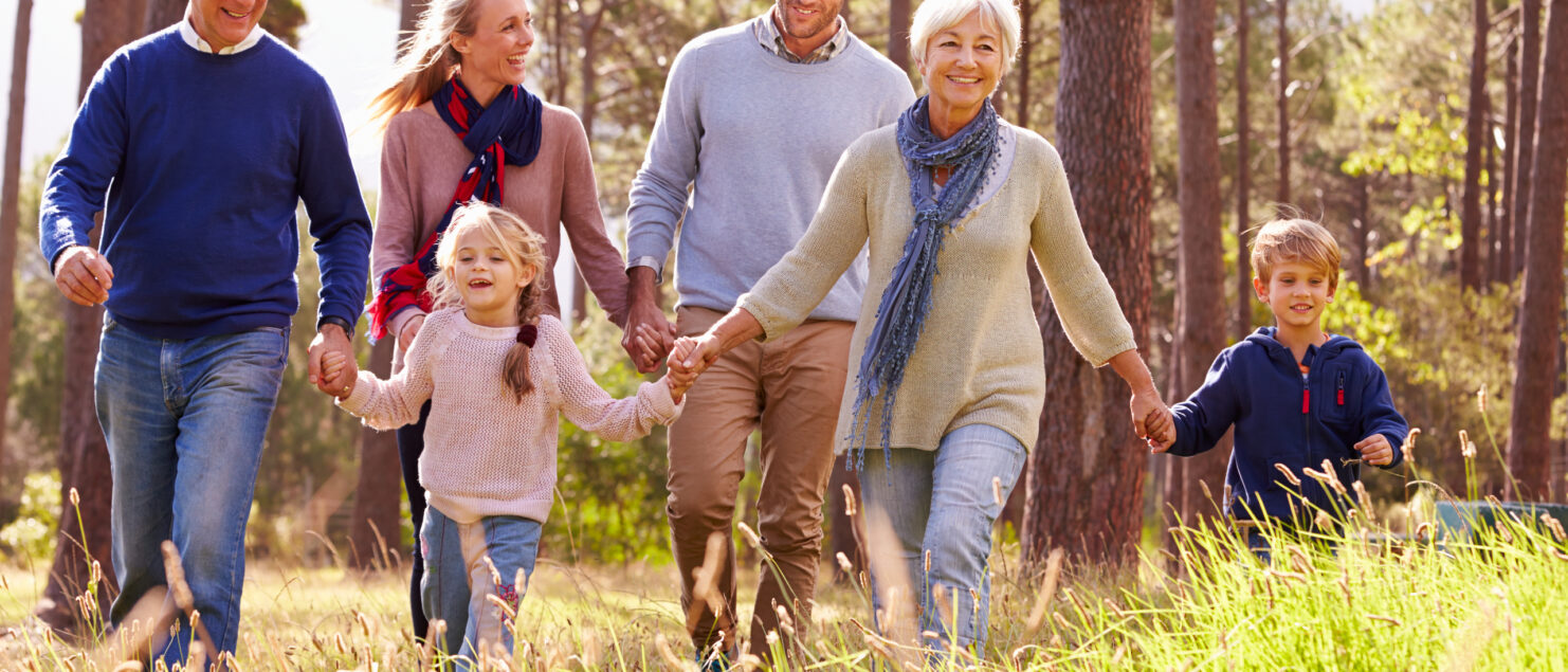 A multi-generational family walking through the countryside.