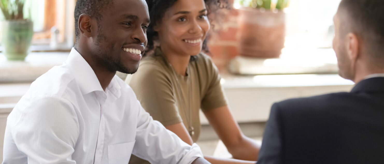 A couple talking to a financial planner.