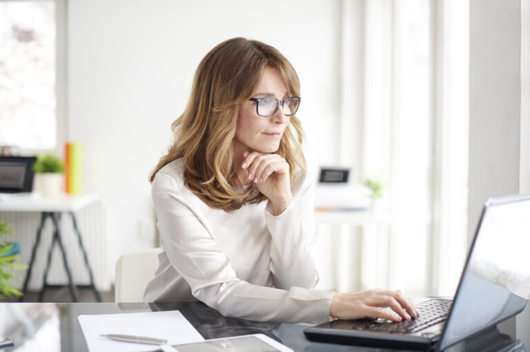 A businesswoman working on a computer.