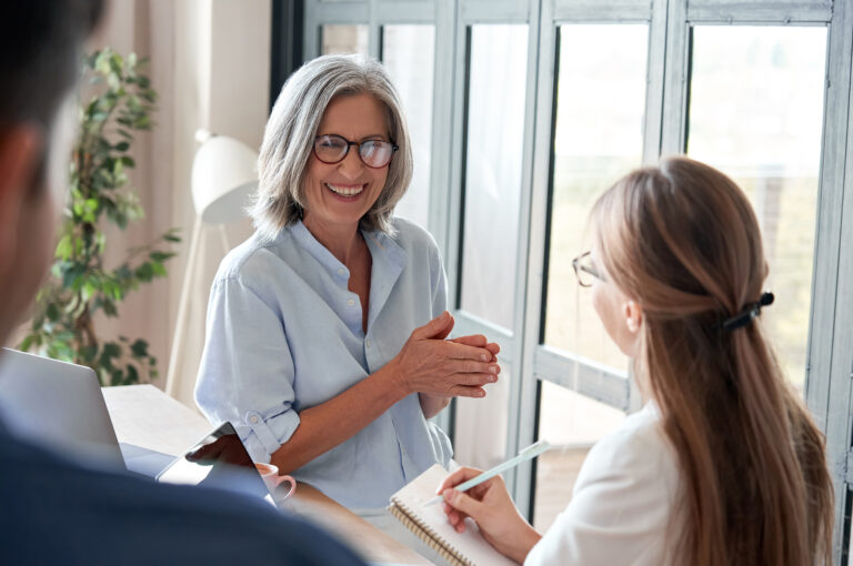 A mature businesswoman coaches a younger colleague