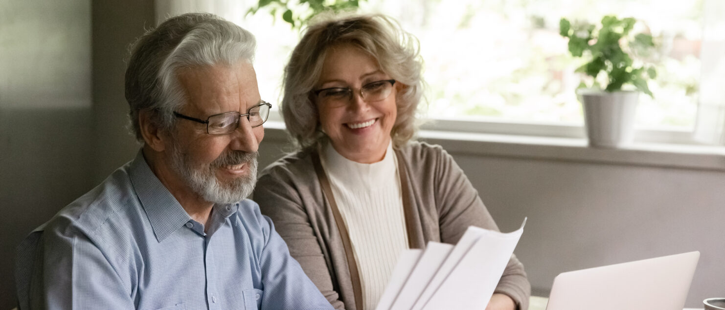 A man and woman looking at some paperwork.