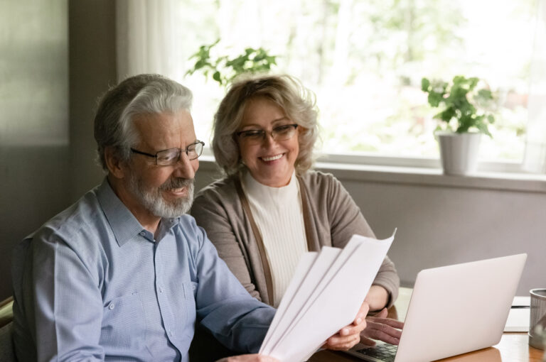 A man and woman looking at some paperwork.