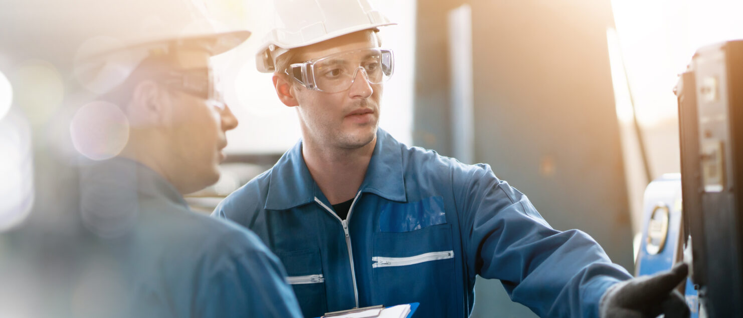 Two workers in a factory.