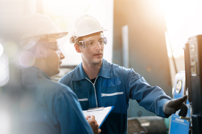 Two workers in a factory.