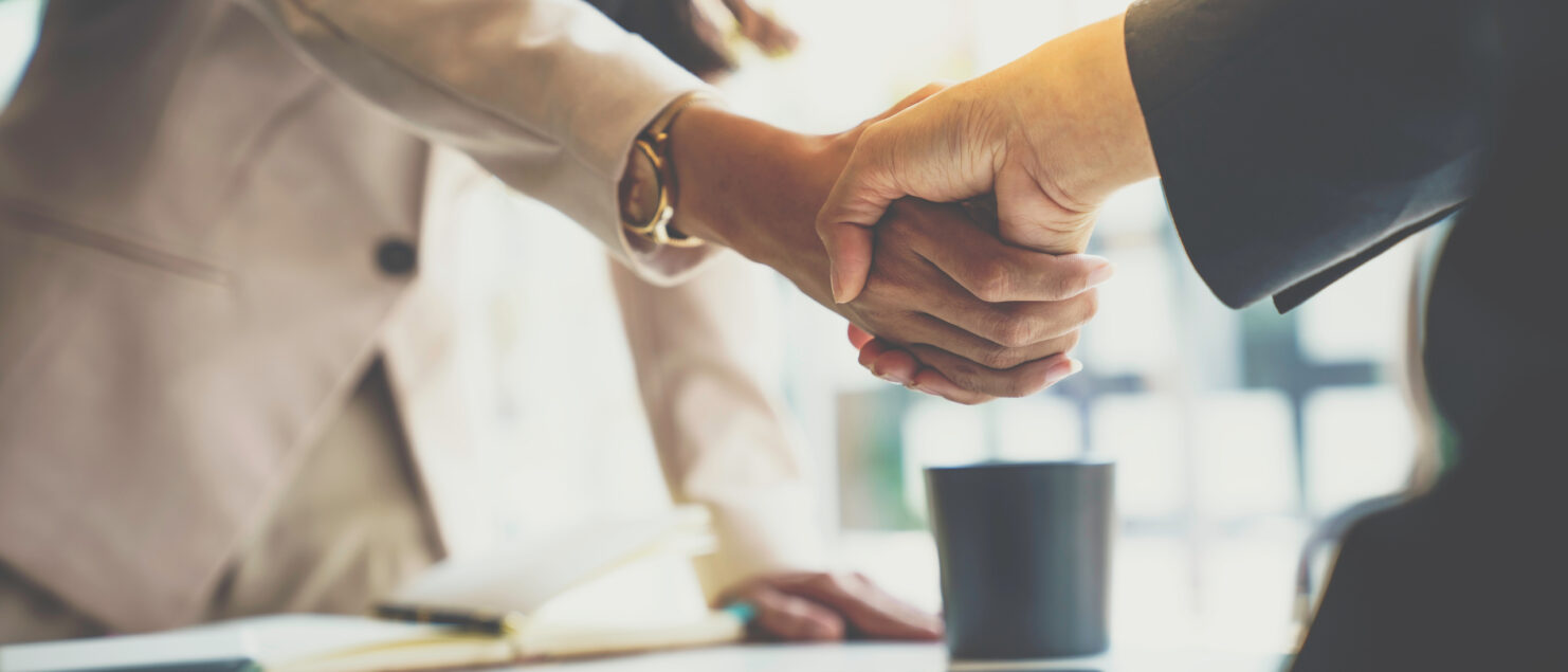 Two business owners shake hands