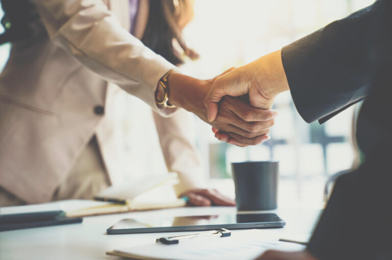 Two business owners shake hands