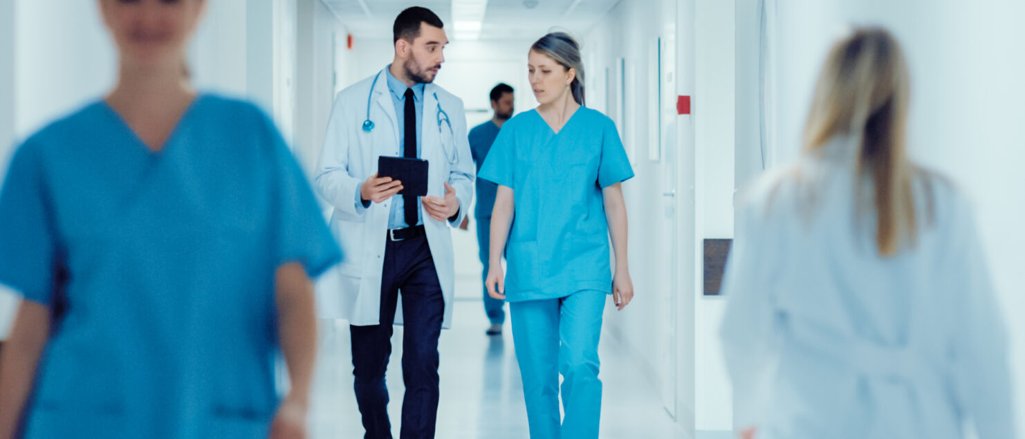 Doctors walking down a hospital corridor.